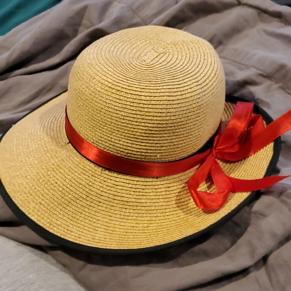 Straw hat, black rim and band. Added red ribbon.
